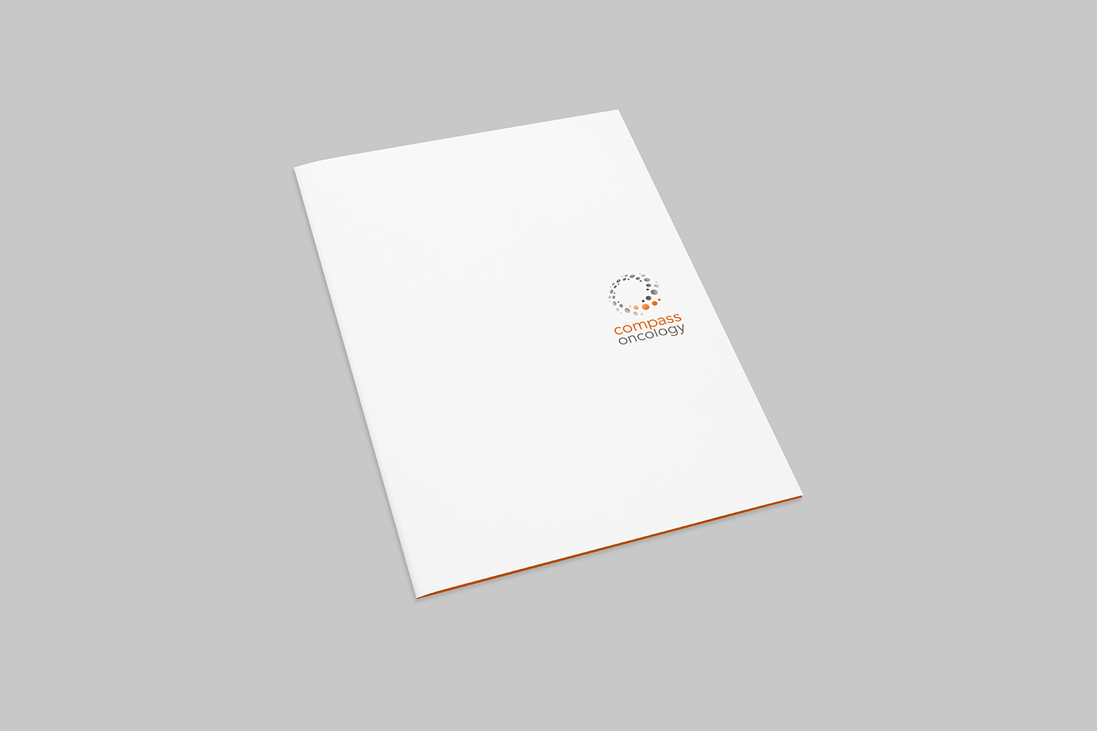 Stationary design. Compass Oncology folder cover design. Logo on a white background with hints of an orange inside. By William Moschell Design Works. Honolulu, Hawaii stationary graphic designer.