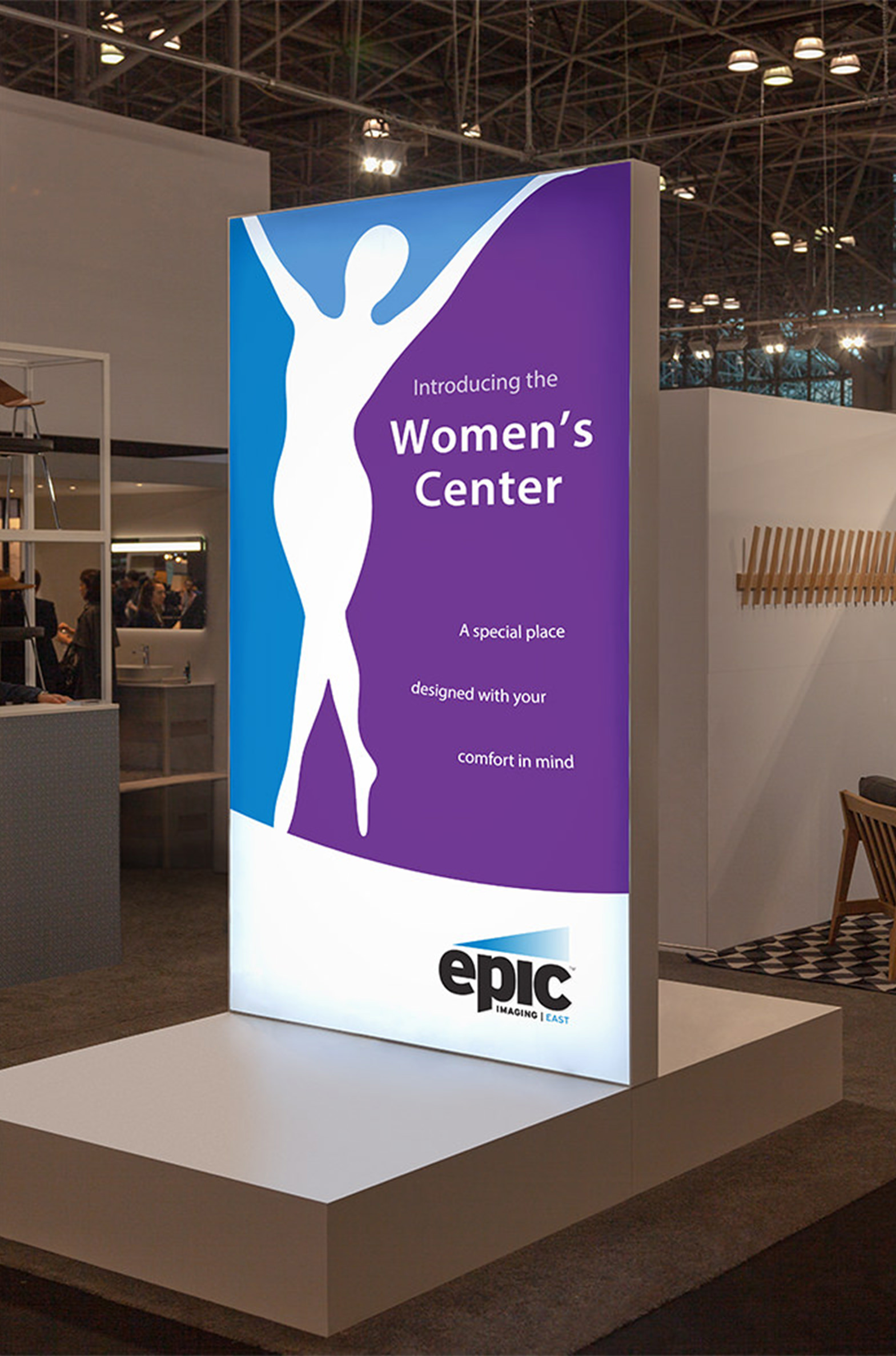 Store display sign design. Epic Women's Center Sign and logo design. The logo is the silhouette of a woman dancing. By William Moschell Design Works. Honolulu, Hawaii medical signage graphic designer.