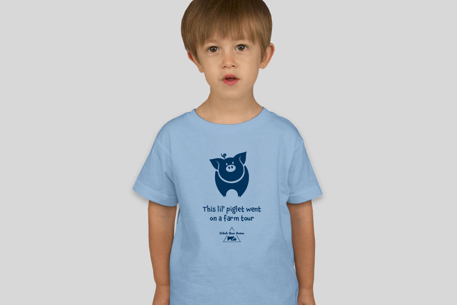 Toddler wearing a shirt with a pig illustration